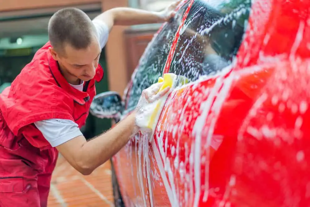 A man is cleaning the car